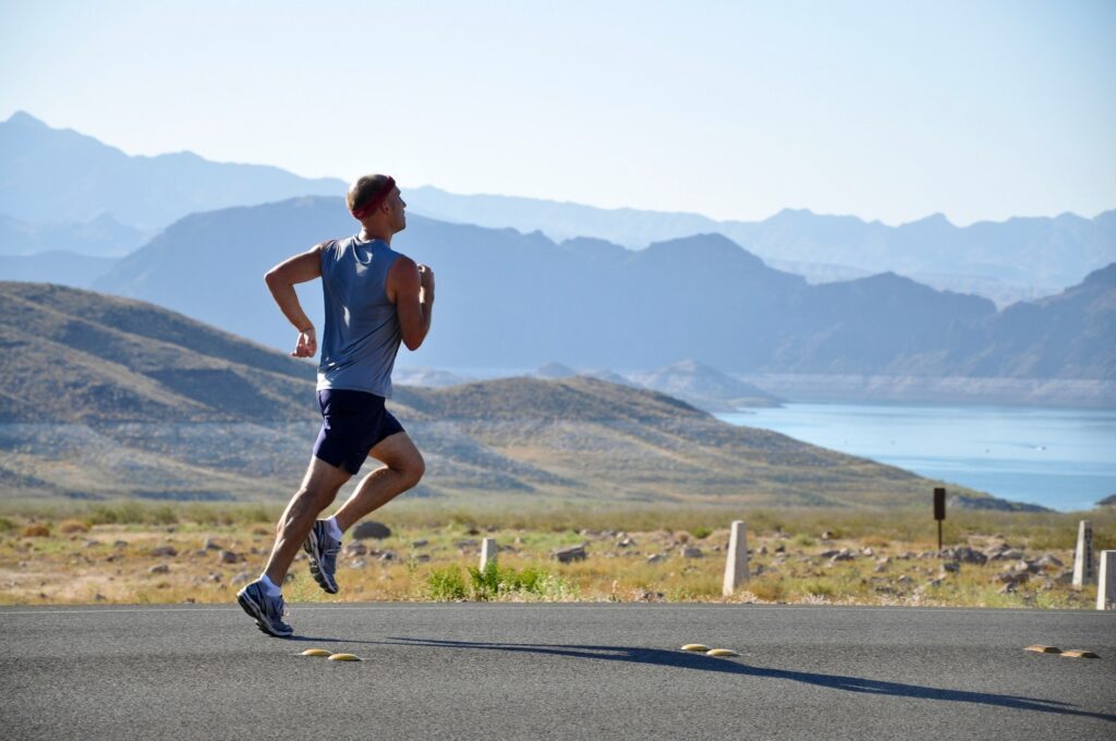 Man running in daylight, highlighting how consistent fitness activities contribute to building confidence and a positive self-image