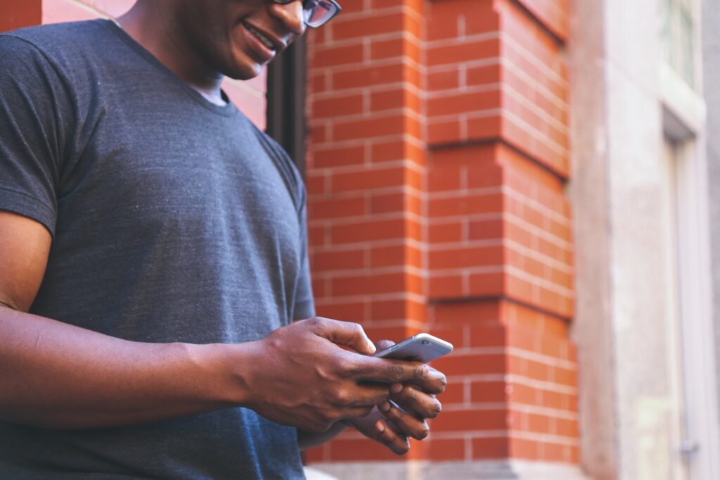 A man intently looking at his phone, representing engagement with social media