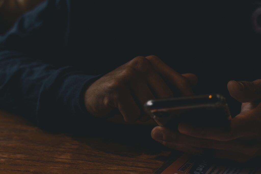 Closeup of a man scrolling on his phone, representing successful direct messaging strategies