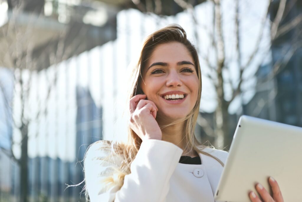 woman-in-white-blazer-holding-tablet-computer-789822